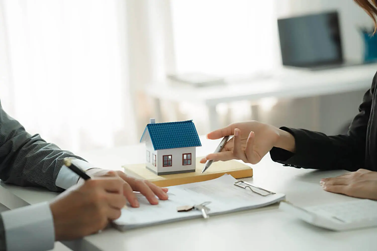 Buyer and real estate professional reviewing documents after an offer is accepted during the home buying process, showing what happens after an offer is accepted