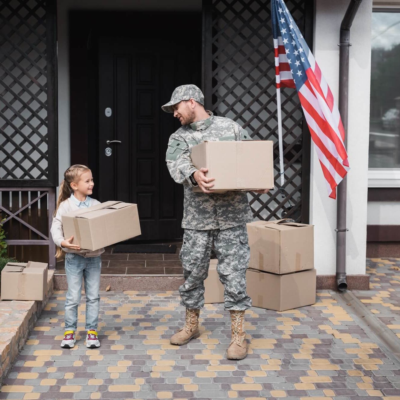 military father and daughter moving boxes